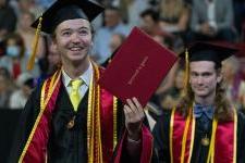 Two undergraduate graduates of DU at the 2022 commencement ceremony.