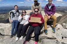 Jon Velotta 和 his students researchers sit at the top of Mt Blue Sky, formerly known as Mt. 埃文斯.